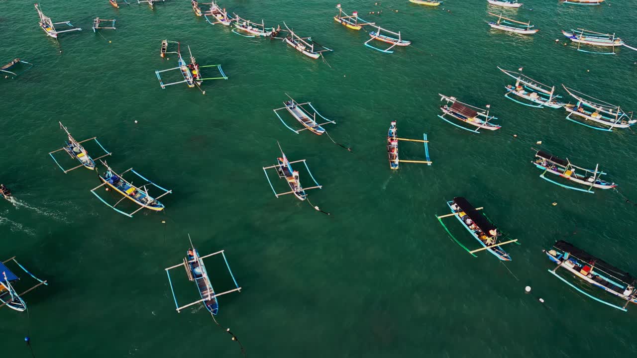 Tropical Bali harbor with wooden outriggers clustered in clear turquoise sea, emphasizing traditional fishing culture, local heritage, and the beauty of Indonesia’s maritime scenery