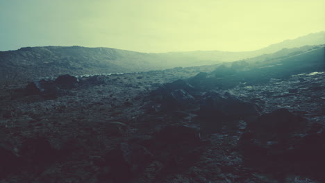 Snow-covered-rocky-hill-in-middle-of-desert-on-cloudy-day