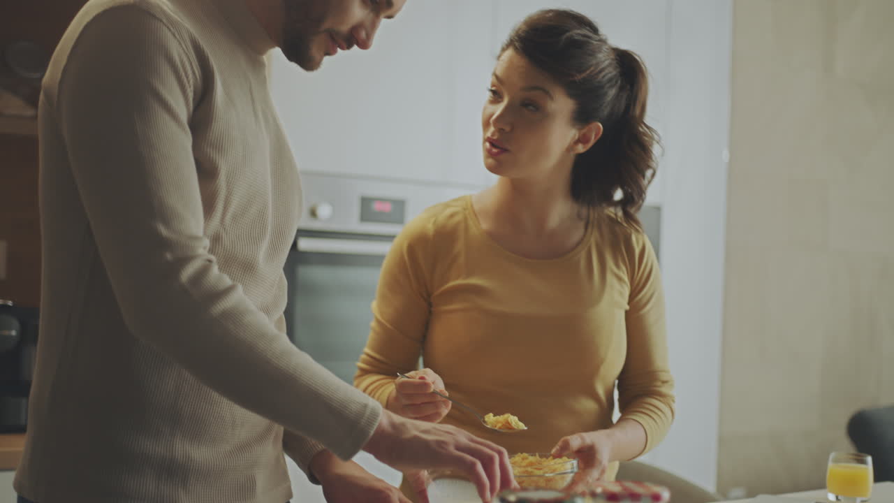 Couple Eating Breakfast in Kitchen
