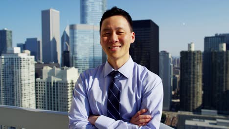 portrait of asian chinese businessman on skyscraper rooftop