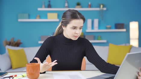 Portrait-of-angry-and-troubled-young-entrepreneur-woman-working-in-home-office.