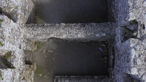 aerial top-down movement and tilt reveal annaghdown abbey