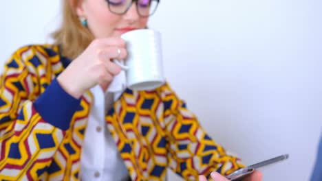hermosa mujer de negocios caucásica bebiendo café y usando una tableta digital en una oficina moderna 4k