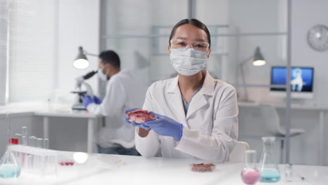 scientist examining a meat sample in a laboratory