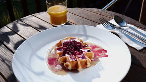 belgian waffle with maple syrup and berry compote