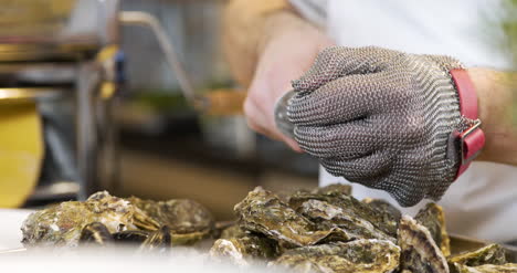 Chef-Preparing-Oysters-Dish-In-Elegant-Restaurant-1