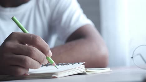 person taking notes with a pencil