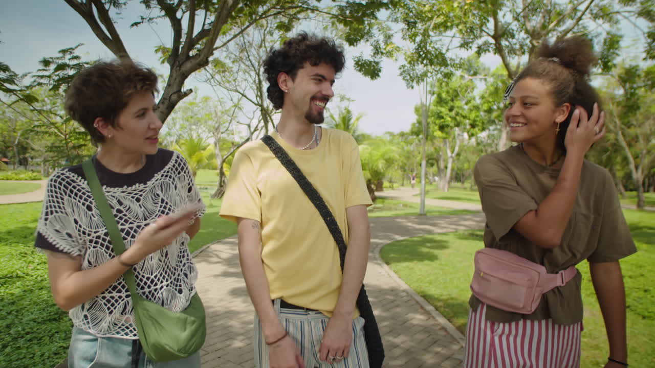 Young Friends Walking and Talking in Park