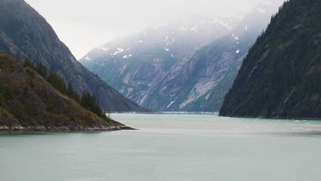 endicott arm, alaska. sailing through the narrow fjord on a foggy morning.