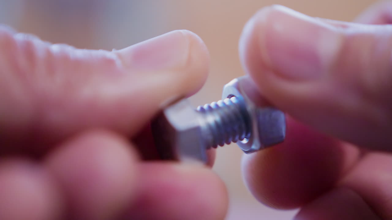 성인 백인 남성 손가락은 볼트를 시계 방향으로 육각형 나사로 돌리고 닫습니다.