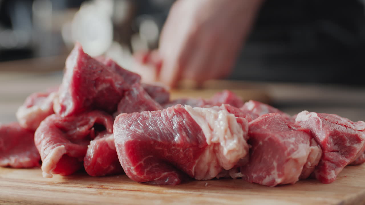 poner pedazos de carne cruda en la tabla de cortar