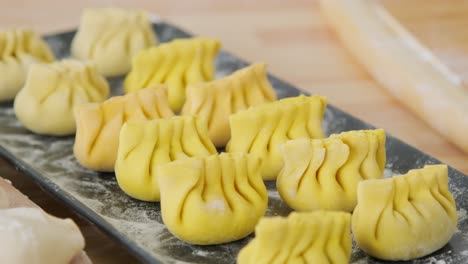 Preparing-dumplings-from-scratch,-they-are-located-on-the-plate-just-before-the-baking-process