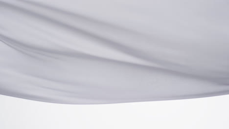 animation of white fabric blowing with copy space over white background