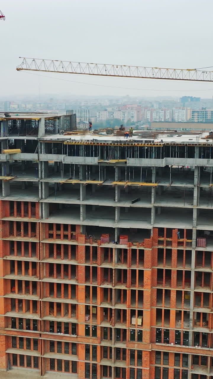 Construction of a residential apartment complex. Aerial view. Vertical video