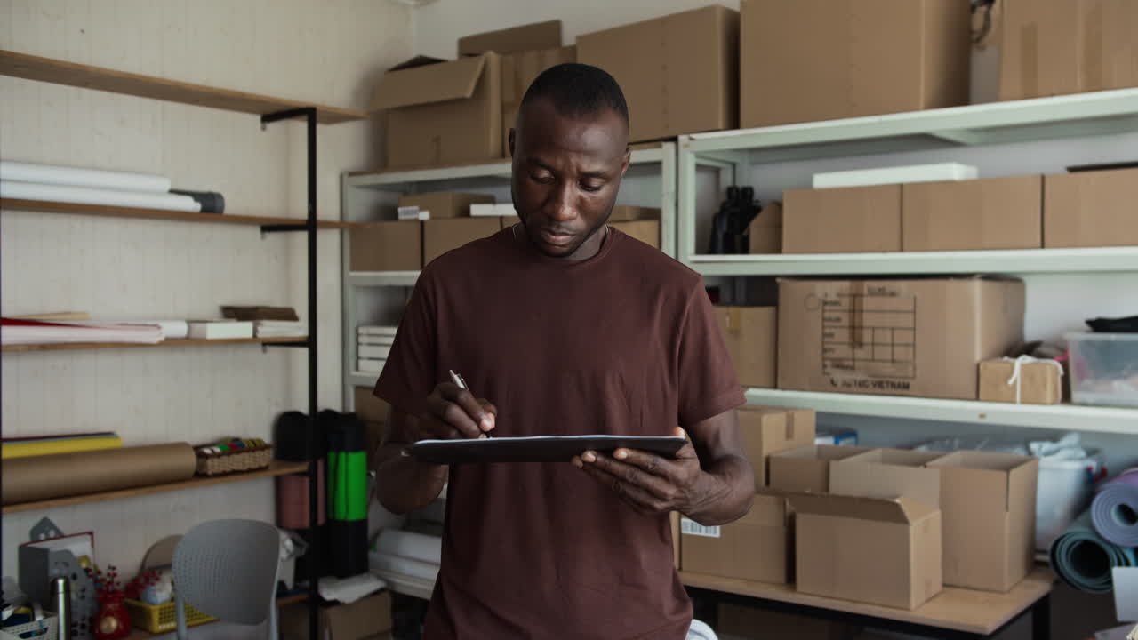 Portrait of Warehouse Worker Filling Delivery Document