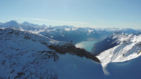 mountaineer-on-high-snow-covered-mountain-summits-along-river-valley