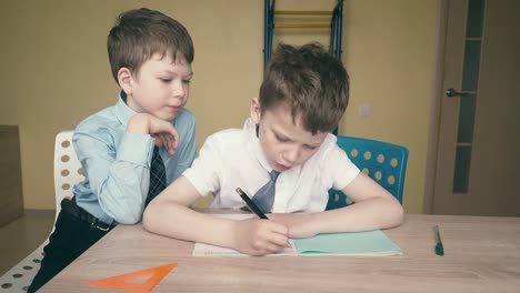 tracking pupils do homework write numbers in notebooks help each other