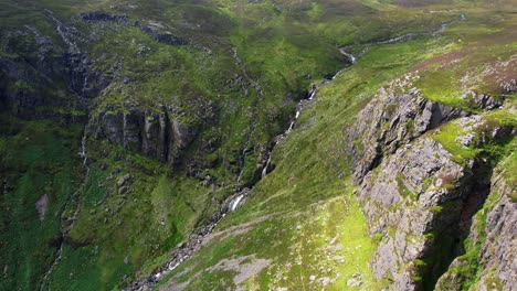 ireland epic drone flying over high cliffs to the mahon falls in the comeragh mountain range waterford ireland dramatic light