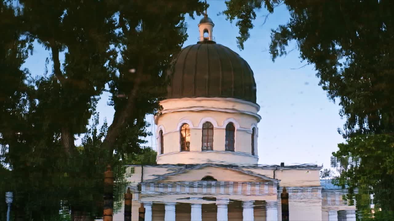 CHISINAU, MOLDOVA - AUGUST 28, 2018: Close-up shot of the Nativity Cathedral's reflection in the water near the central park in Chisinau, Moldova