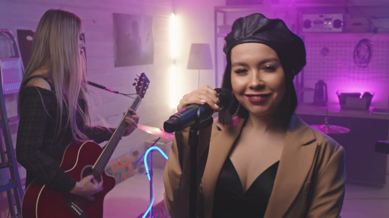 Female Rock Group Performing In Night Club