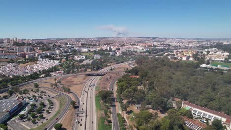 tilt up shot of the lisbon city fire event from a distance. highway traffic in portugal