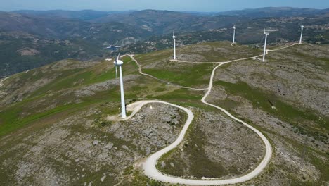 wind-turbine-rotating-on-top-of-a-mountain-overlooking-Gerês,-renewable-wind-energy-portugal