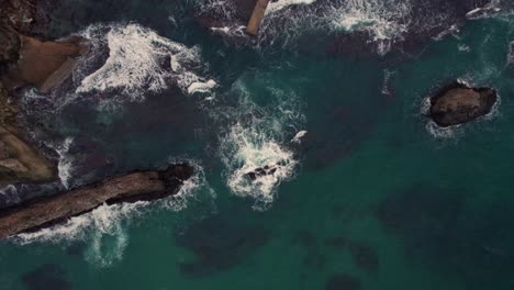 Aerial-drone-top-down-breaking-Waves-rotate-360-Japan-Kyotango-Beach-Travel-Sea-Kyoto-natural-turquoise-blue-water,-destination-of-cliffs-and-rocks-around-bay,-establishing-shot