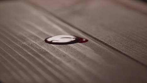 Droplets-Of-Red-Blood-On-Wooden-Table