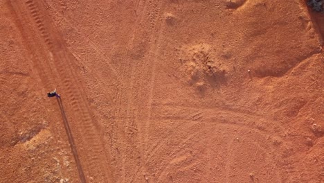 Top-view-of-old-man-crossing-desertic-area