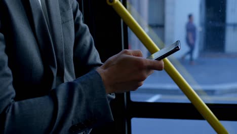 Business-commuter-using-mobile-phone-while-travelling-in-bus-4k