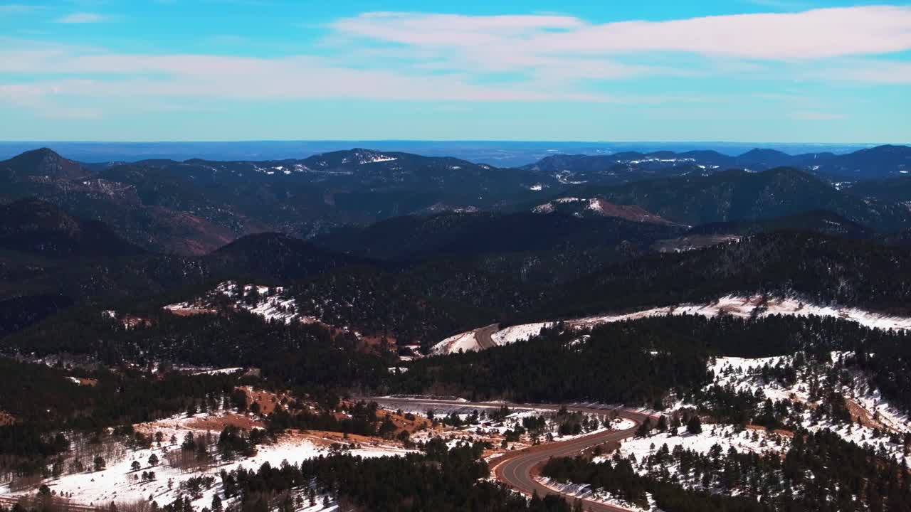 Central City Parkway Denver city scape Black Hawk Idaho Springs Gilpin County aerial drone Colorado winter snow historic Gold mining town road highway blue sky sunny clouds Rocky Mountains forward