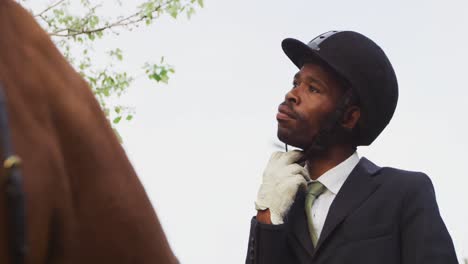 african american man riding his dressage horse