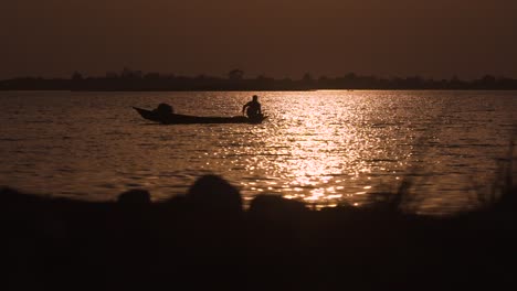 fisherman fishing at sunset in central indian lake