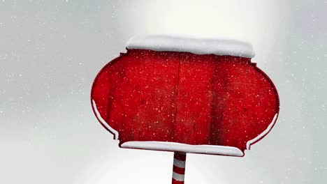 snow falling over red wooden sign post against white background