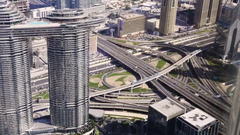 slow motion shot looking over sheik zayed road intersection from the burj khalifa, dubai