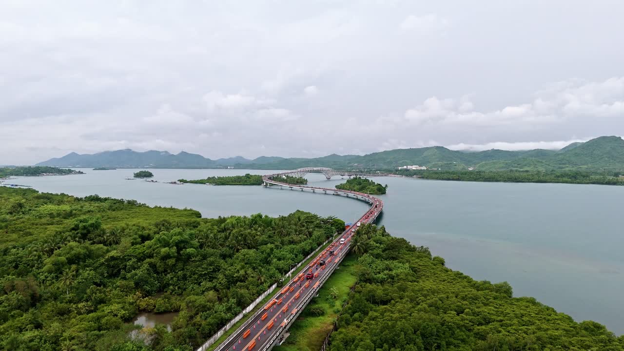 Aerial view of San Juanico Bridge, connecting Leyte to Samar over lush vegetation and water.