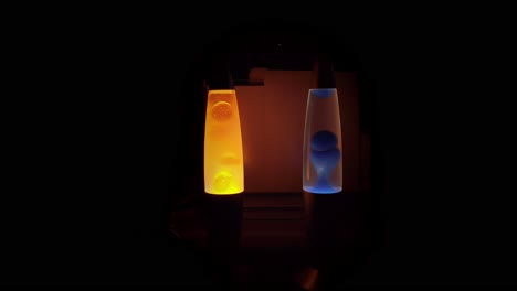 two lava lamps glowing in the dark