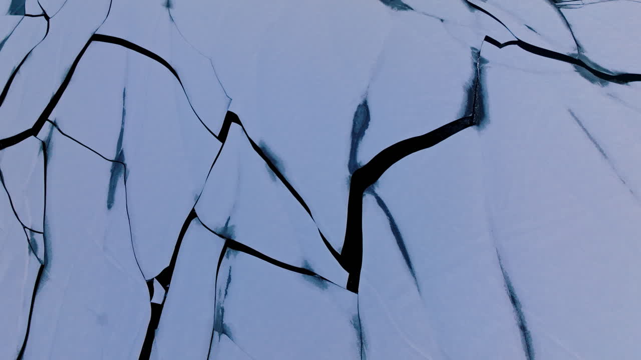 A drone soaring over enormous ice formations on the water's surface
