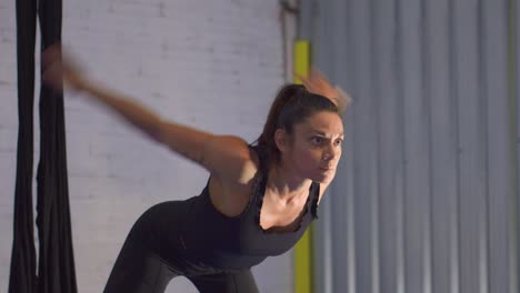 mujer calentando y estirando los brazos en el gimnasio visto desde el frente, calentamiento de la parte superior del cuerpo