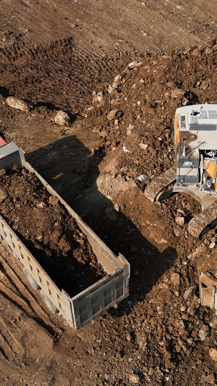 Excavator Loading Dump Truck with Dirt