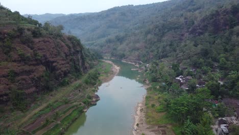 beautiful aerial view of a river in the middle of the mountains in the morning