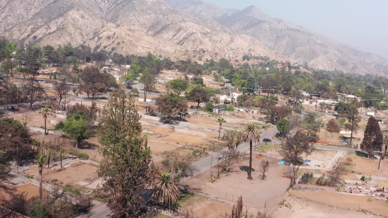 Aerial low rising shot of cleared residential lots burned by the Eaton Fire in Altadena, California. 4K