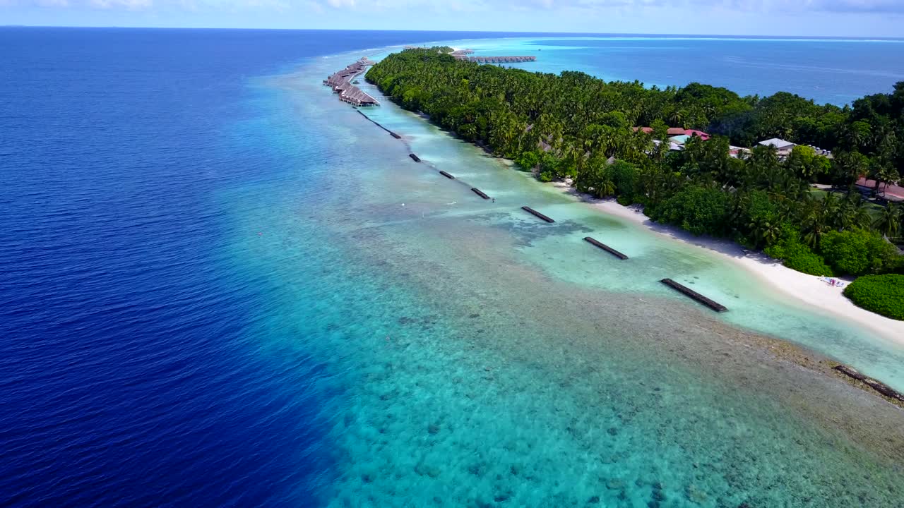 isla en maldivas - paraíso tropical de árboles verdes, arena blanca y villas de playa rodeadas de agua azul del océano - toma aérea