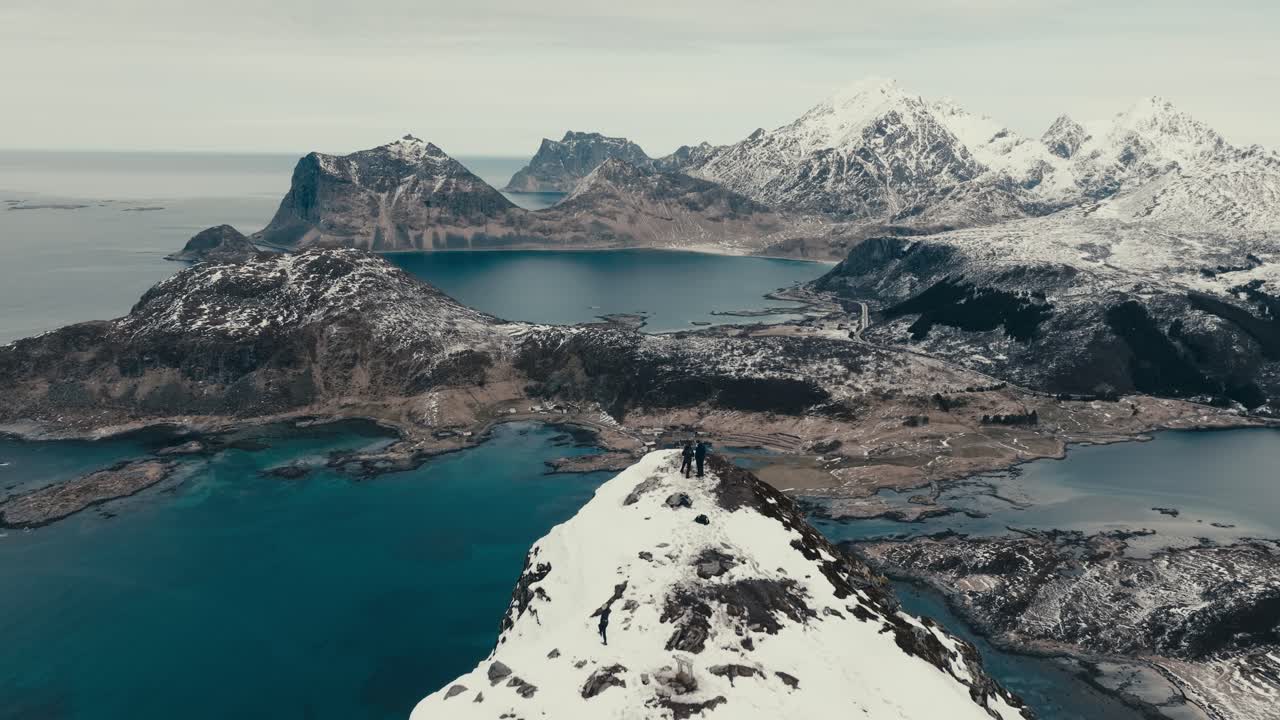 Hiking Over Offersoykammen Mountain Peak In The Lofoten Archipelago, Norway. Aerial Pullback Shot
