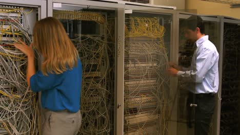 technicians looking at open server locker