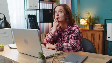 Business woman raises finger feels excited with good idea inspiration motivation using laptop