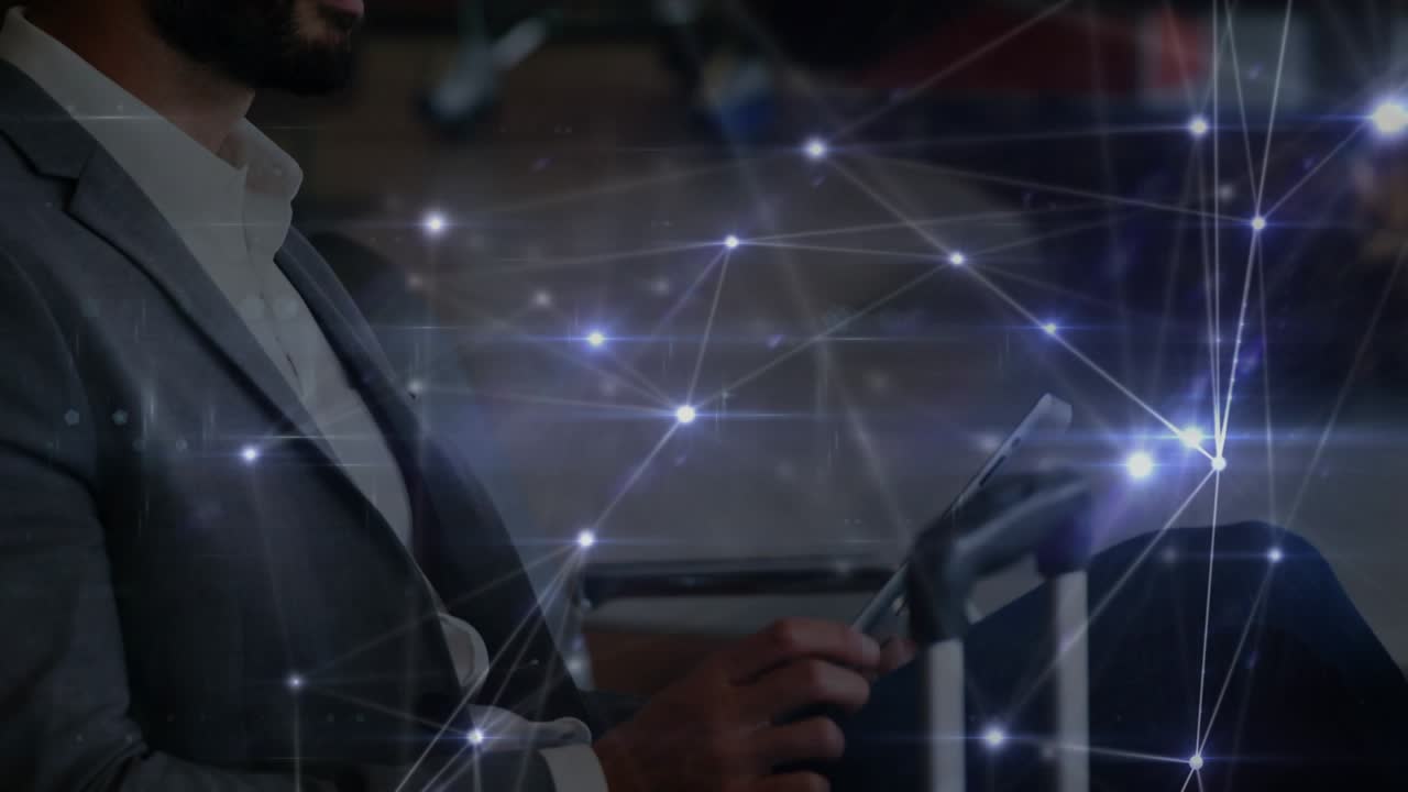 Animation of network of connections over caucasian businessman using tablet