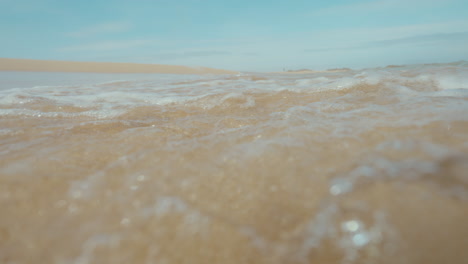 ocean waves on a sandy beach