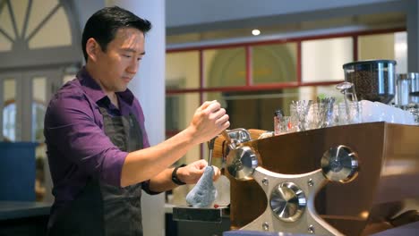 barista cleaning coffee machine in cafe 4k