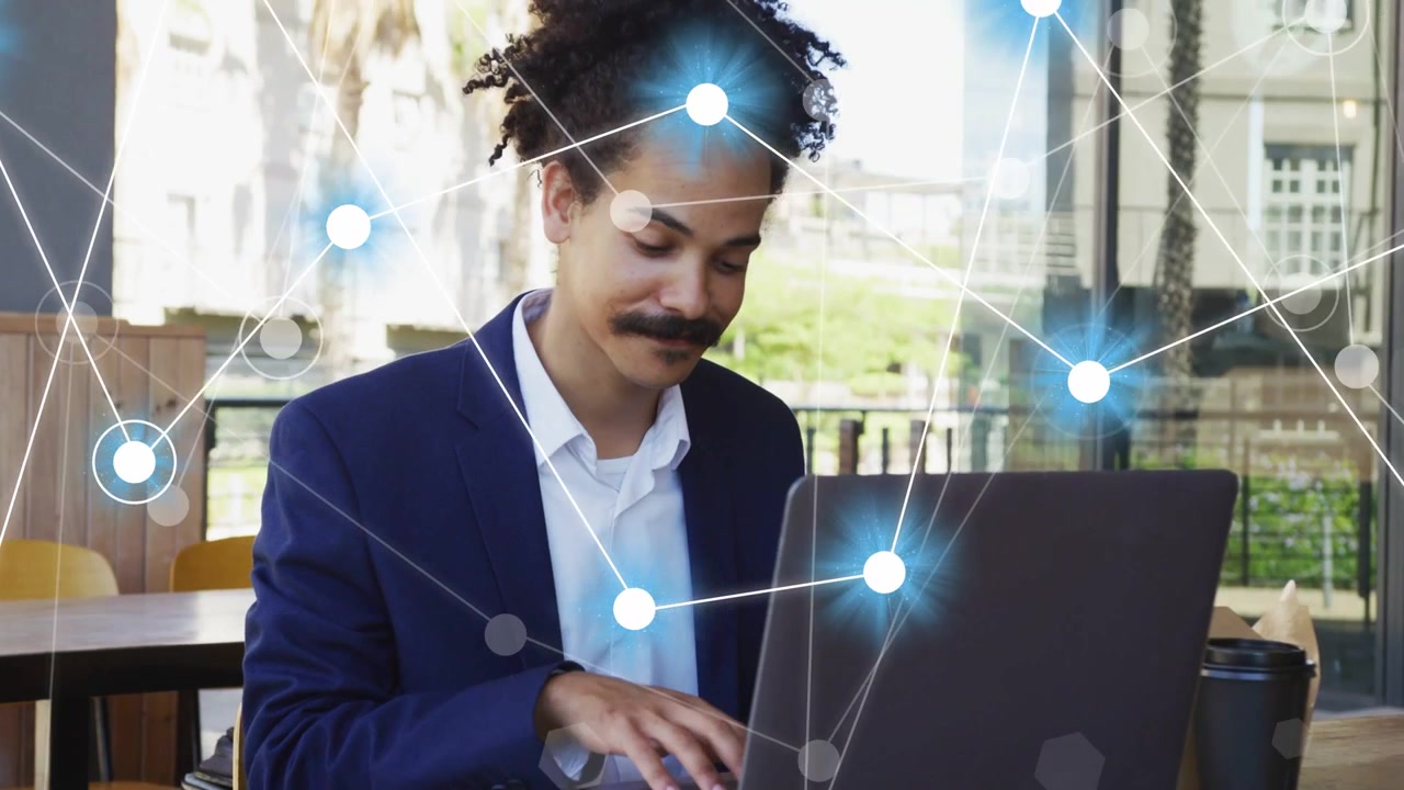 Man opening laptop and typing in cafe, activating node overlay growing across frame for tech work